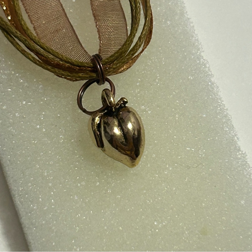 Peach golden tone charm necklace
